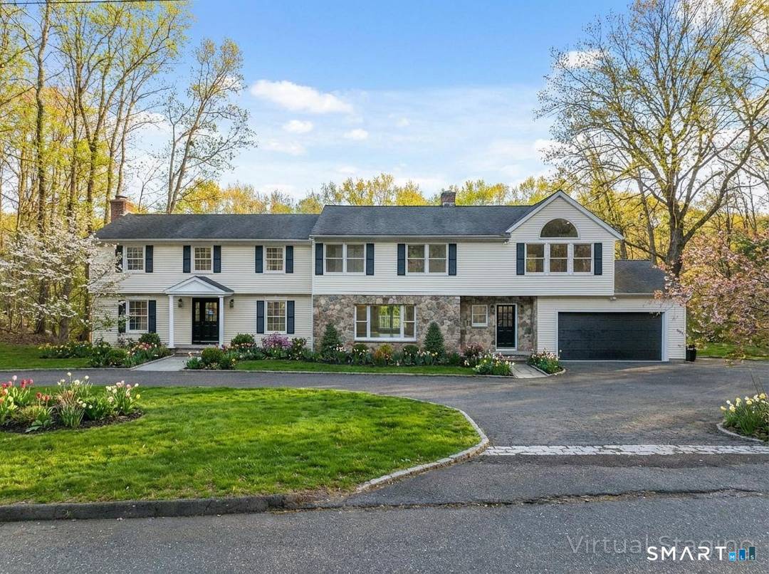 Welcome to this expansive and beautifully updated six bedroom Colonial, offering three full and two half baths and thoughtfully positioned on a sprawling 2.