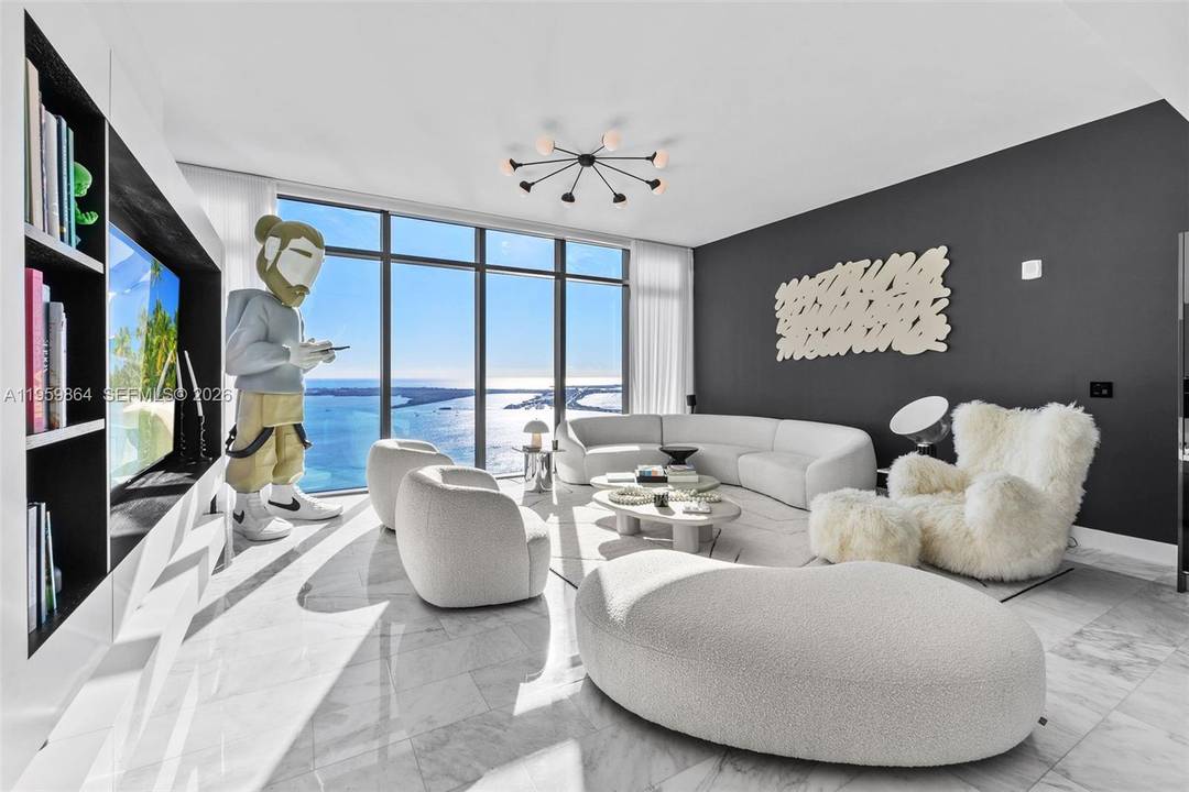 High above Brickell on the 44th floor of Echo, this exceptional corner residence captures sweeping 180 degree views of Biscayne Bay, the Brickell skyline, and the Miami Beach horizon.