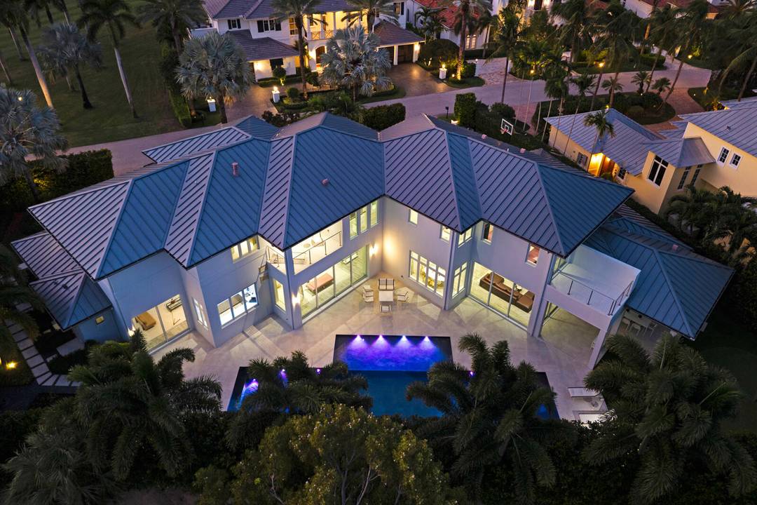 A contemporary, light filled home on an oversized lot with 165 feet of golf course frontage in Royal Palm.