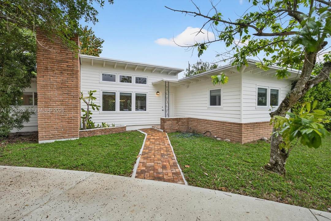Beautiful mid century South Miami home built in 1950, reflecting the South Florida architectural style of the Alfred Browning Parker era with vaulted ceilings, natural light, and open living spaces.