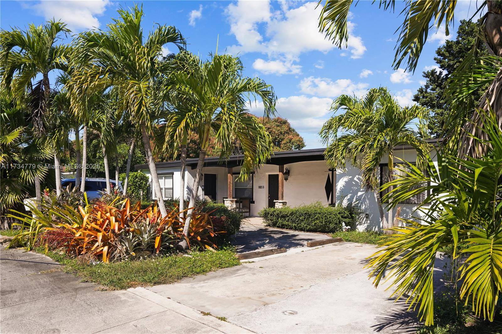 Nestled among majestic trees, this stunning property welcomes you with a graceful circular driveway, offering both elegance and convenience.