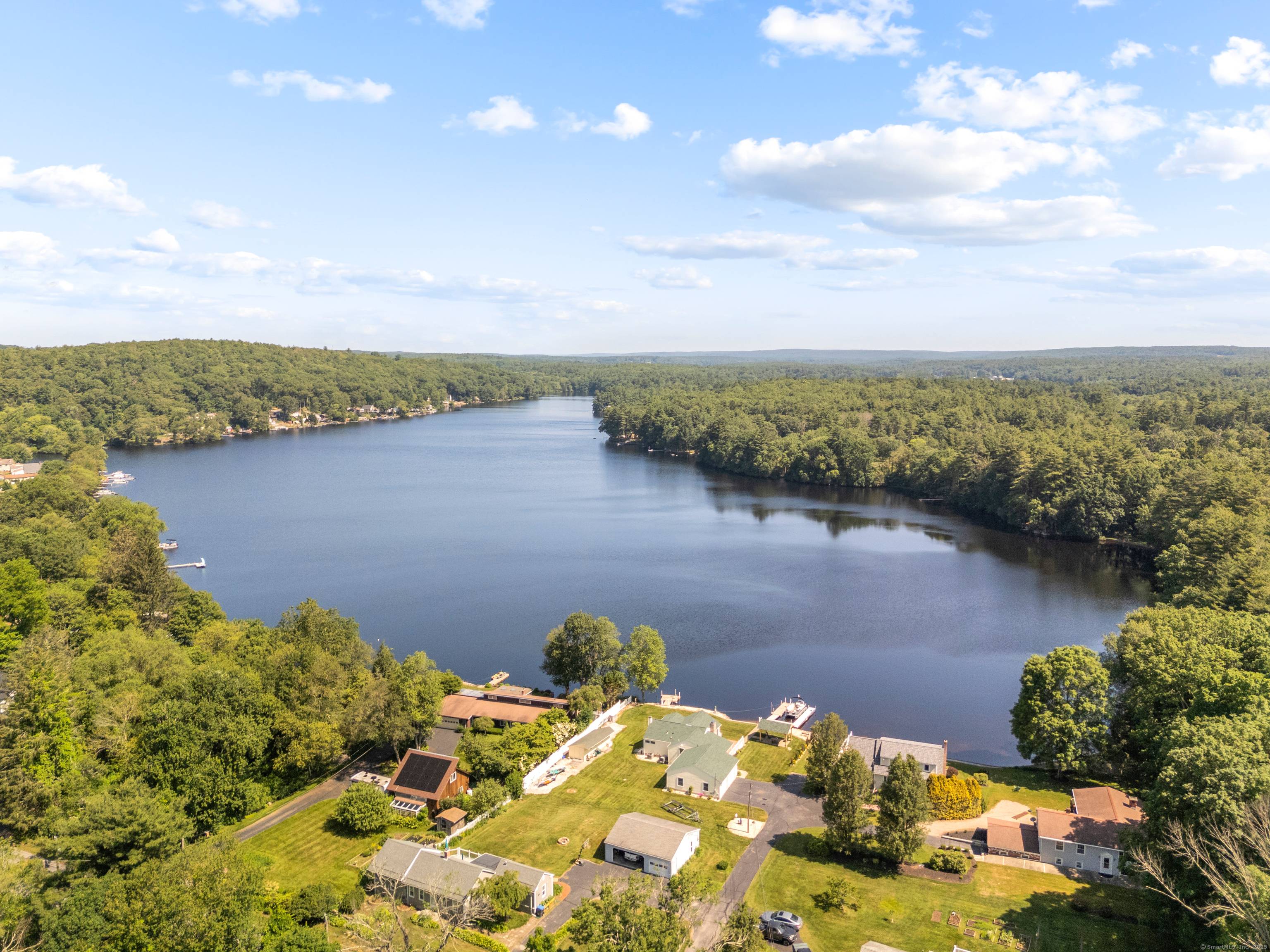 Welcome to your year round lakefront retreat on the private side of desirable Quaddick Lake !