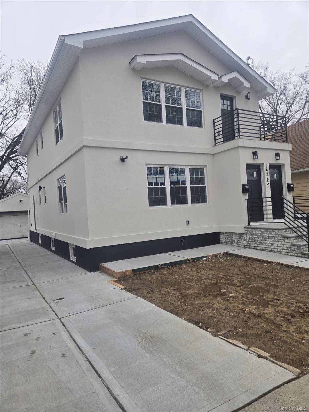 Detached two family home, 6 Bedrooms, 4Baths, complete with a private driveway and a one car garage.