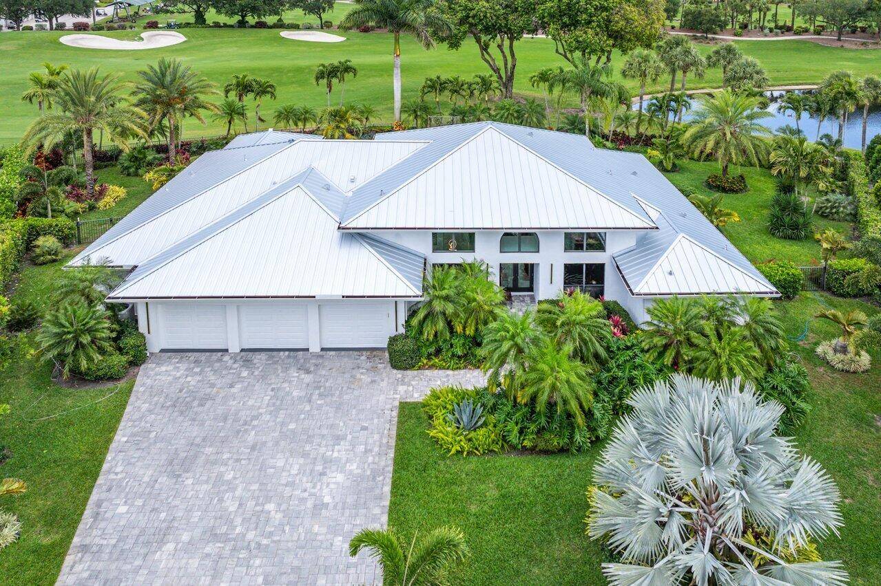 Experience luxury living on a premier cul de sac lot in prestigious Bocaire Country Club.