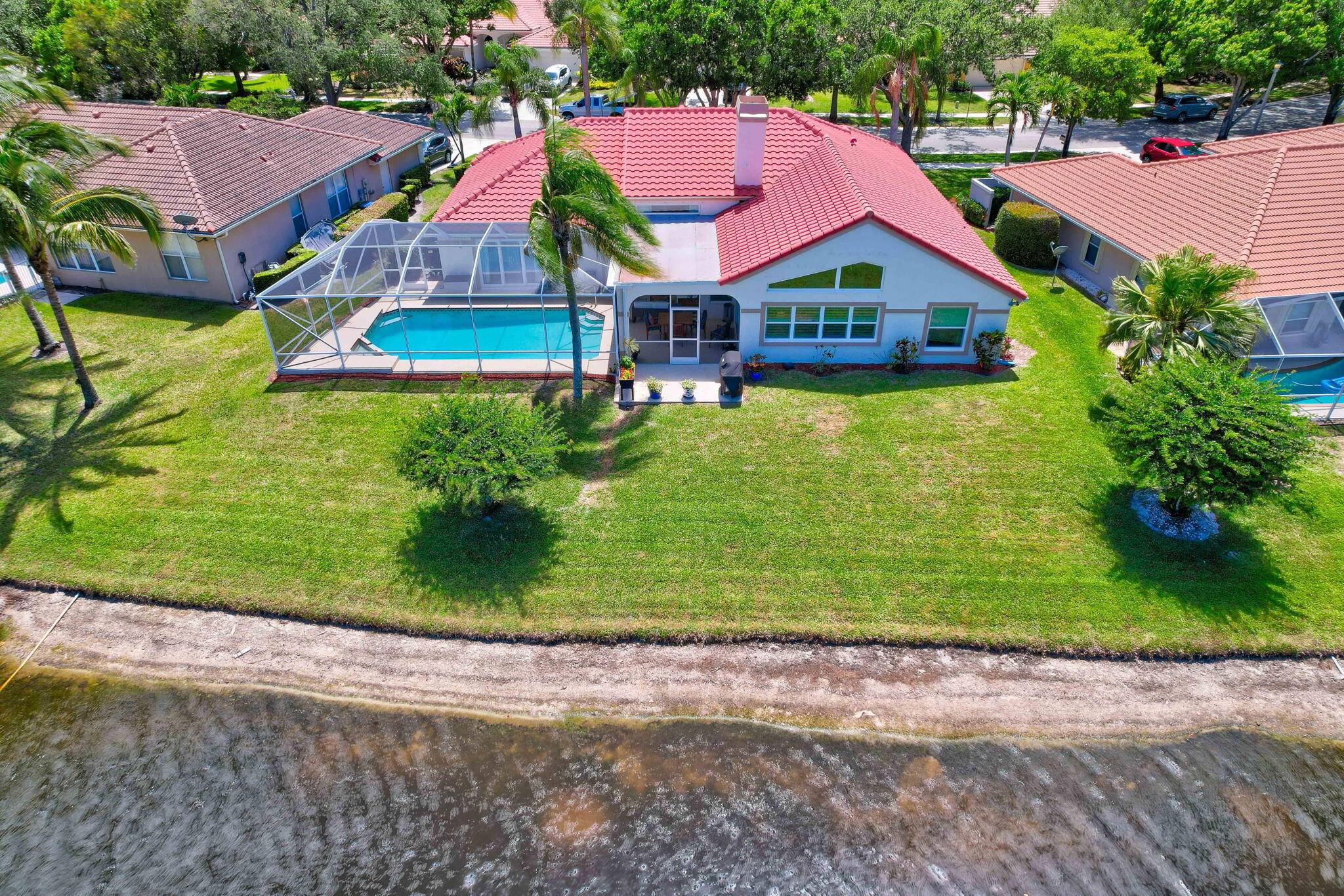 SHORES OF JUPITER Pristine 4BR 3BA lakefront POOL home showcasing elegant upgrades and move in ready comfort.