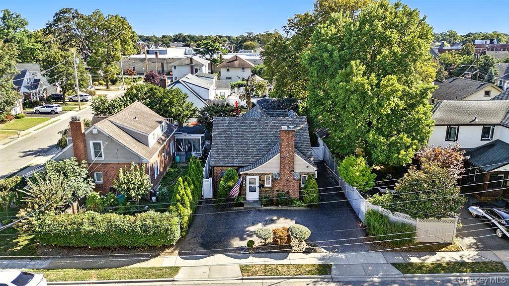 Welcome home to this charming and spacious 4 bedroom, 2 bath expanded Cape in the Village of Rockville Centre.