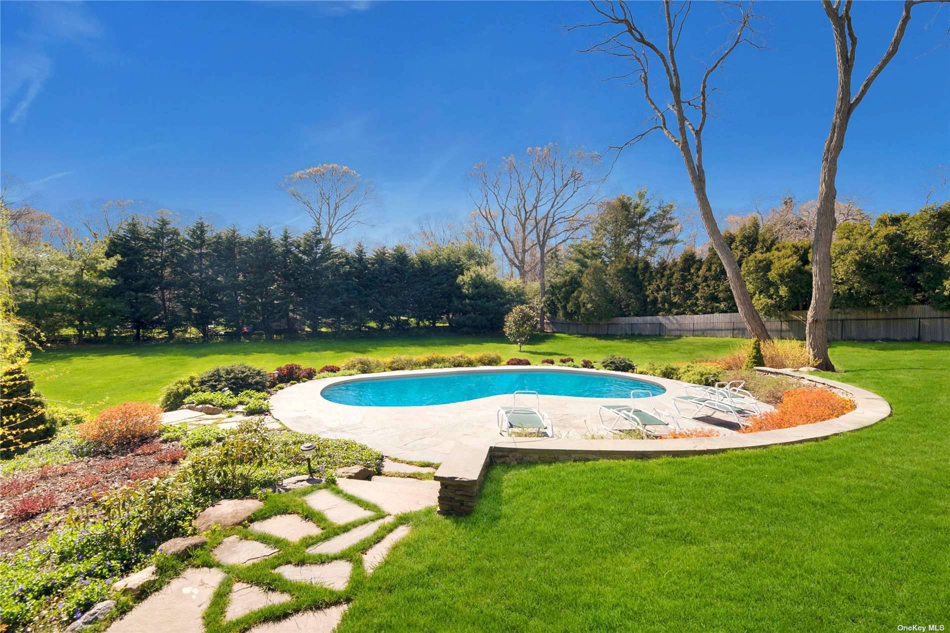 Extraordinary Nassau Point retreat with saltwater pool in an exclusive 1 acre meticulously landscaped setting.