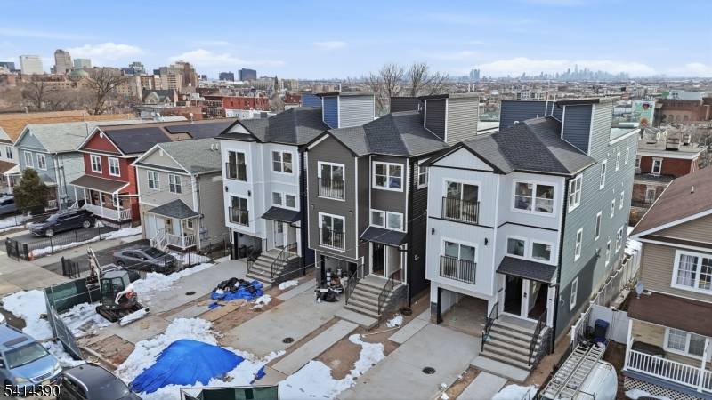 Stunning 3, 876 sq ft property situated exceptional rooftop views overlooking the New York City skyline on a long lot with a large driveway.