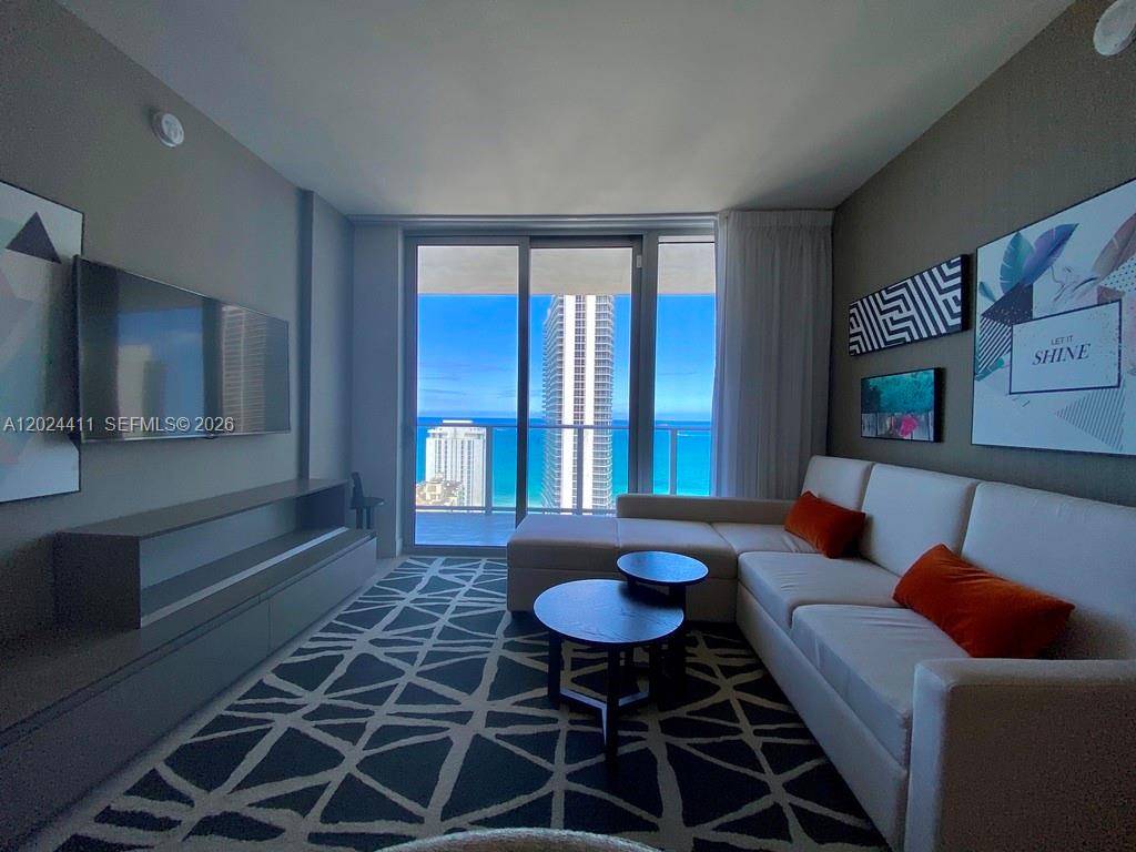 Live where the sand meets the city in this stunning oceanfront residence.