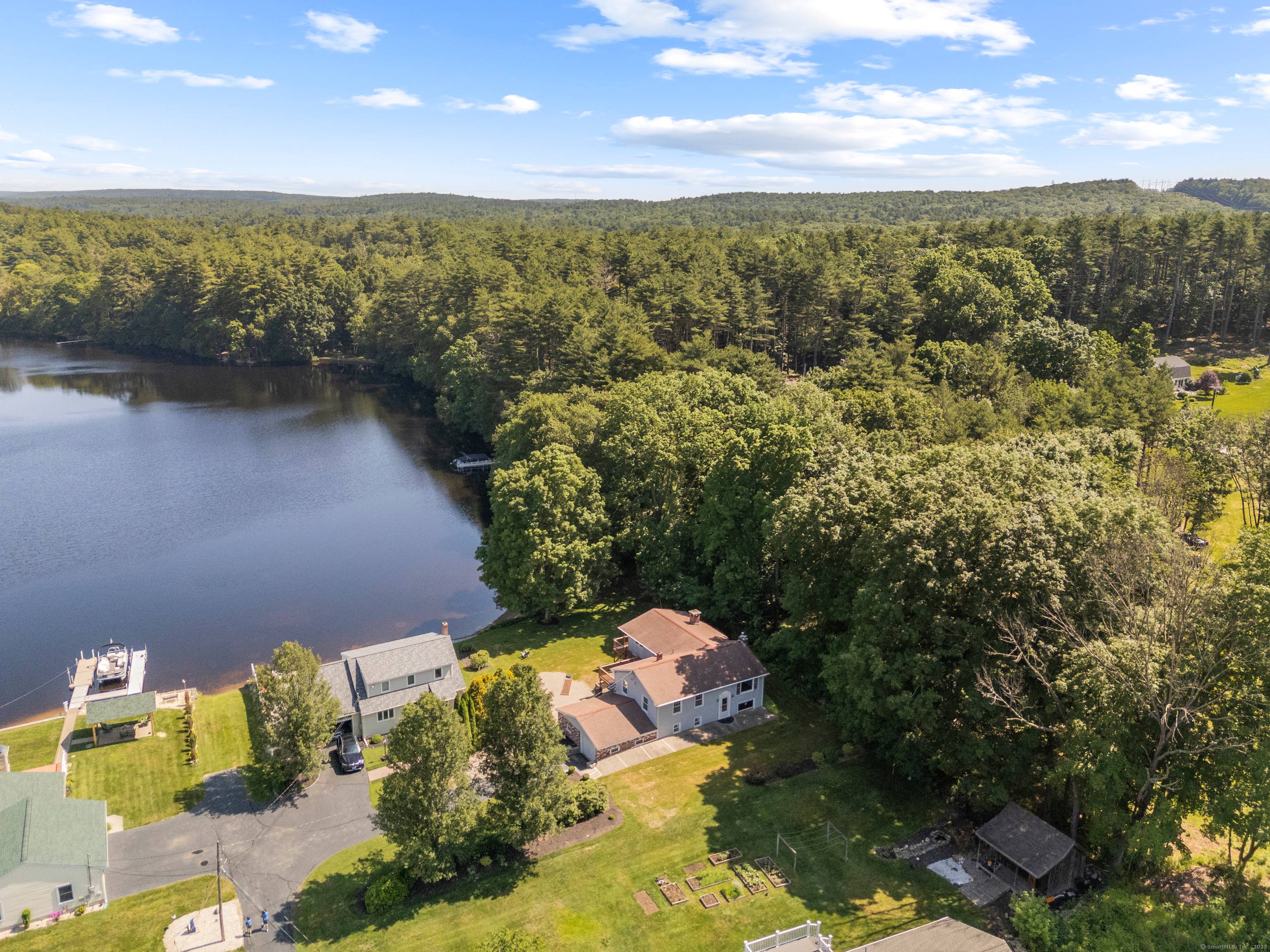 Welcome to your year round lakefront retreat on the private side of desirable Quaddick Lake !