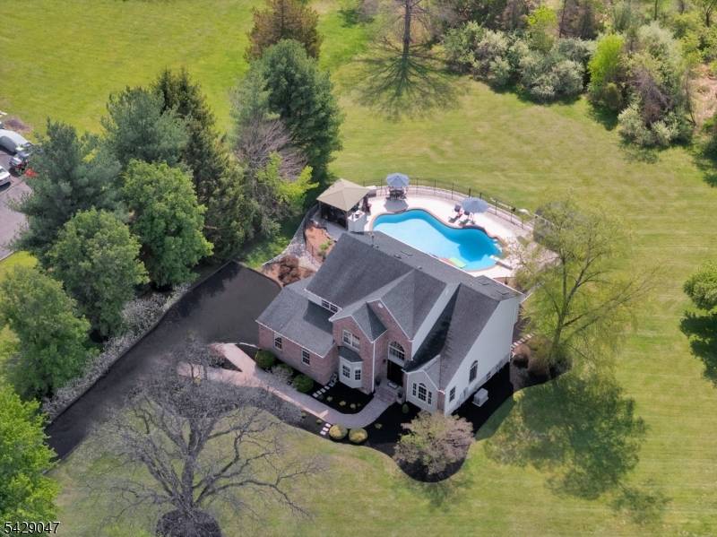 Set on a picturesque 2 acres, backing to woods, this warm inviting 4BR Colonial w approx.