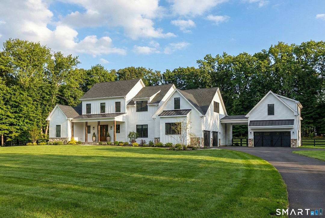 Soaring ceilings, curated finishes, and effortless indoor outdoor living define this exceptional Modern Farmhouse retreat.