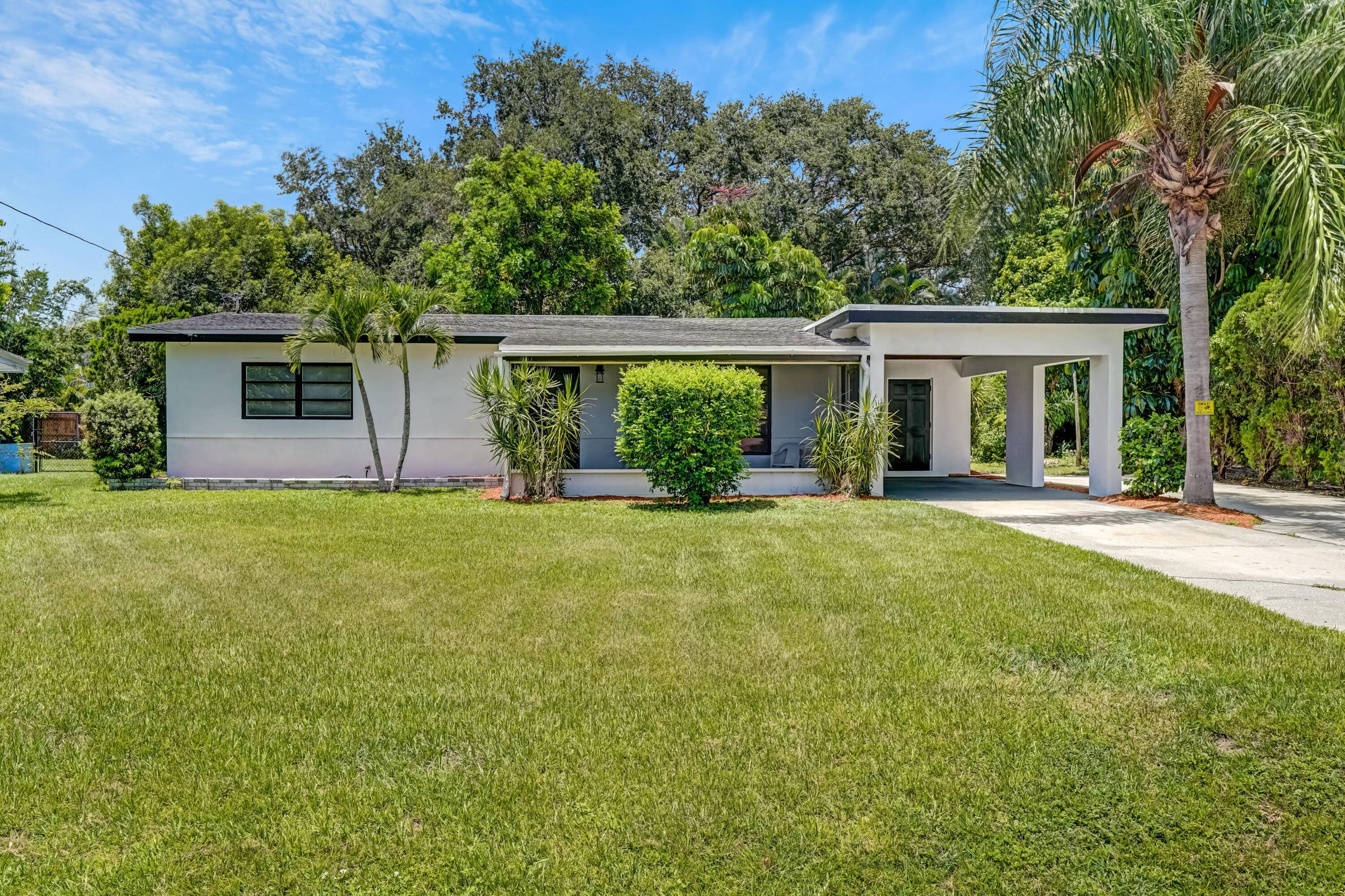 Charming Florida home 3 bedroom, 1 bath that features a 1 car carport, RV Boat driveway, outdoor shower, spacious screened patio, terrazzo floors, midcentury features have been left in place ...