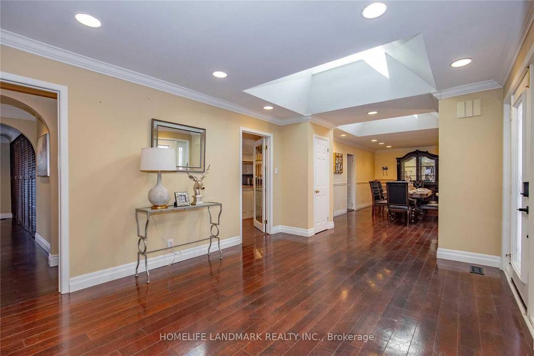 Located in a coveted Southeast Oakville enclave south of Lakeshore Road, this exceptional custom bungalow is set among mature trees and distinguished residences, just moments from Lake Ontario.