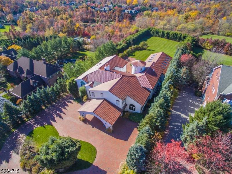 Resting on 1. 5 acres of gorgeous property awaits this expansive Mediterranean estate !