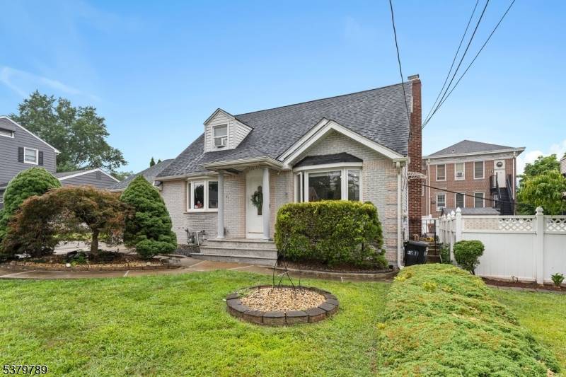 Step into this meticulously maintained home where natural light pours through bay windows into a bright, open living room.