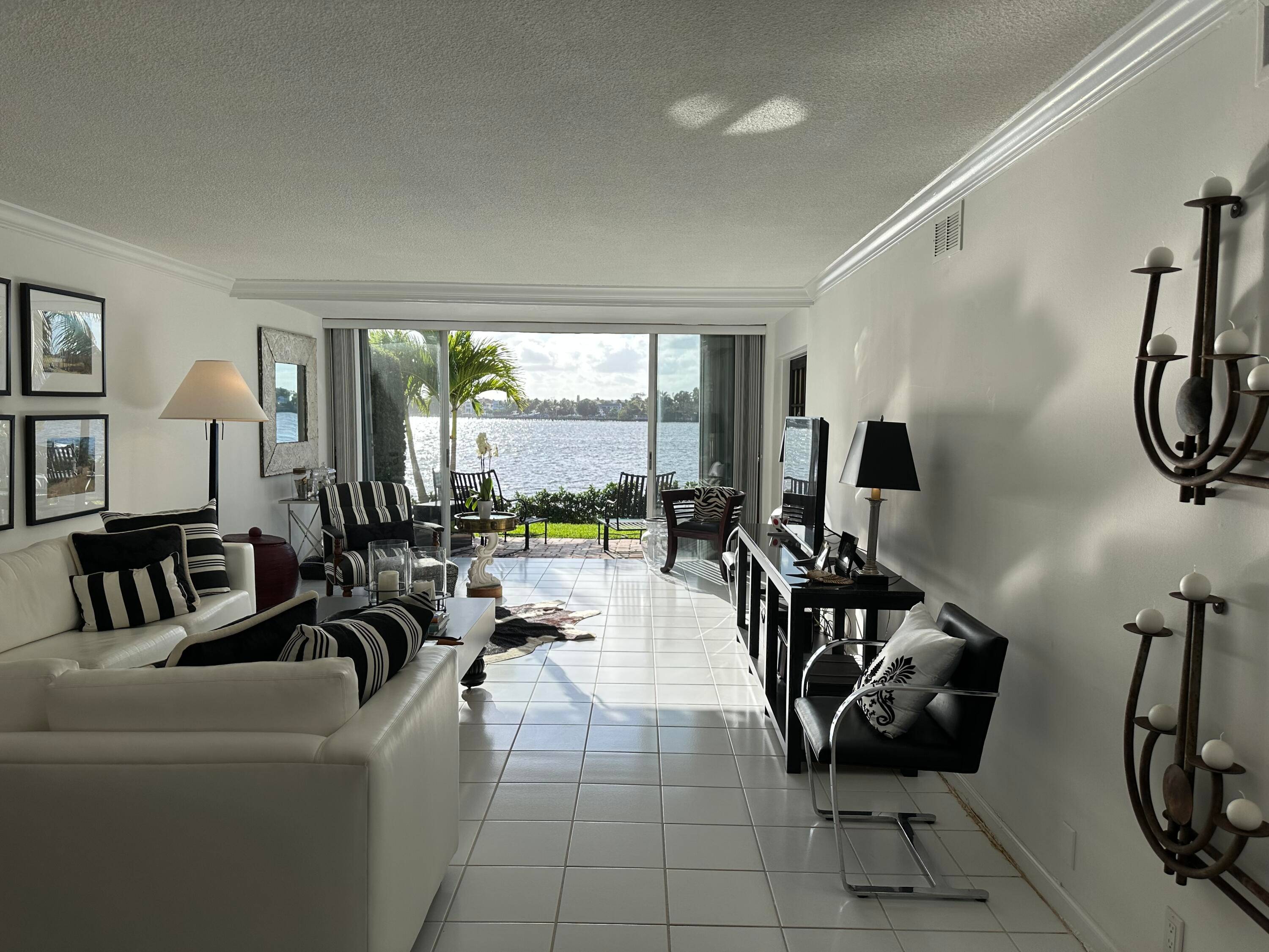 Enjoy extraordinary sunsets from this west facing Direct Intracoastal turnkey !