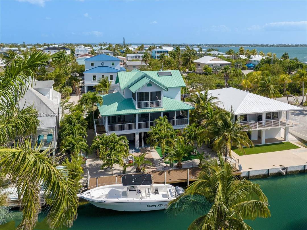 This custom built Jolly Roger Estates home designed by architect Glenn Gray offers indoor outdoor living with multiple inviting porches and excellent, oceanside boat access.