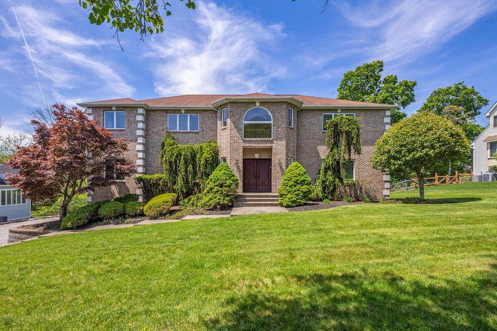 Welcome to 8 Marcus Drive a beautifully maintained brick front residence set on an over sized, expansive, park like property in the heart of desirable Wesley Hills.
