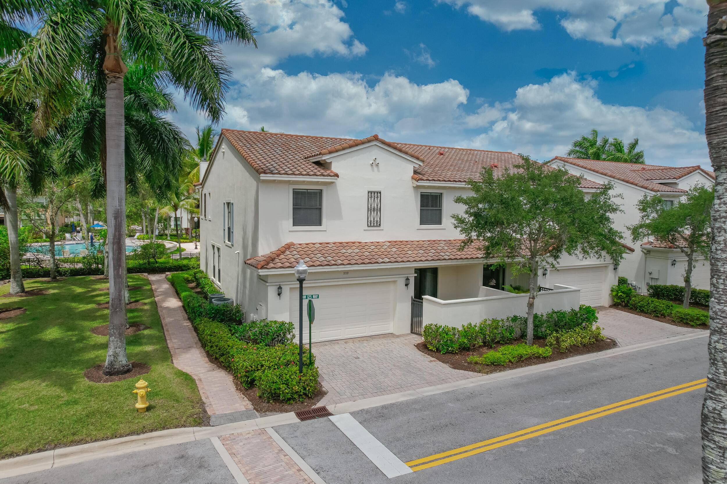 Upscale 2 story corner townhouse in Artesia's resort style community !