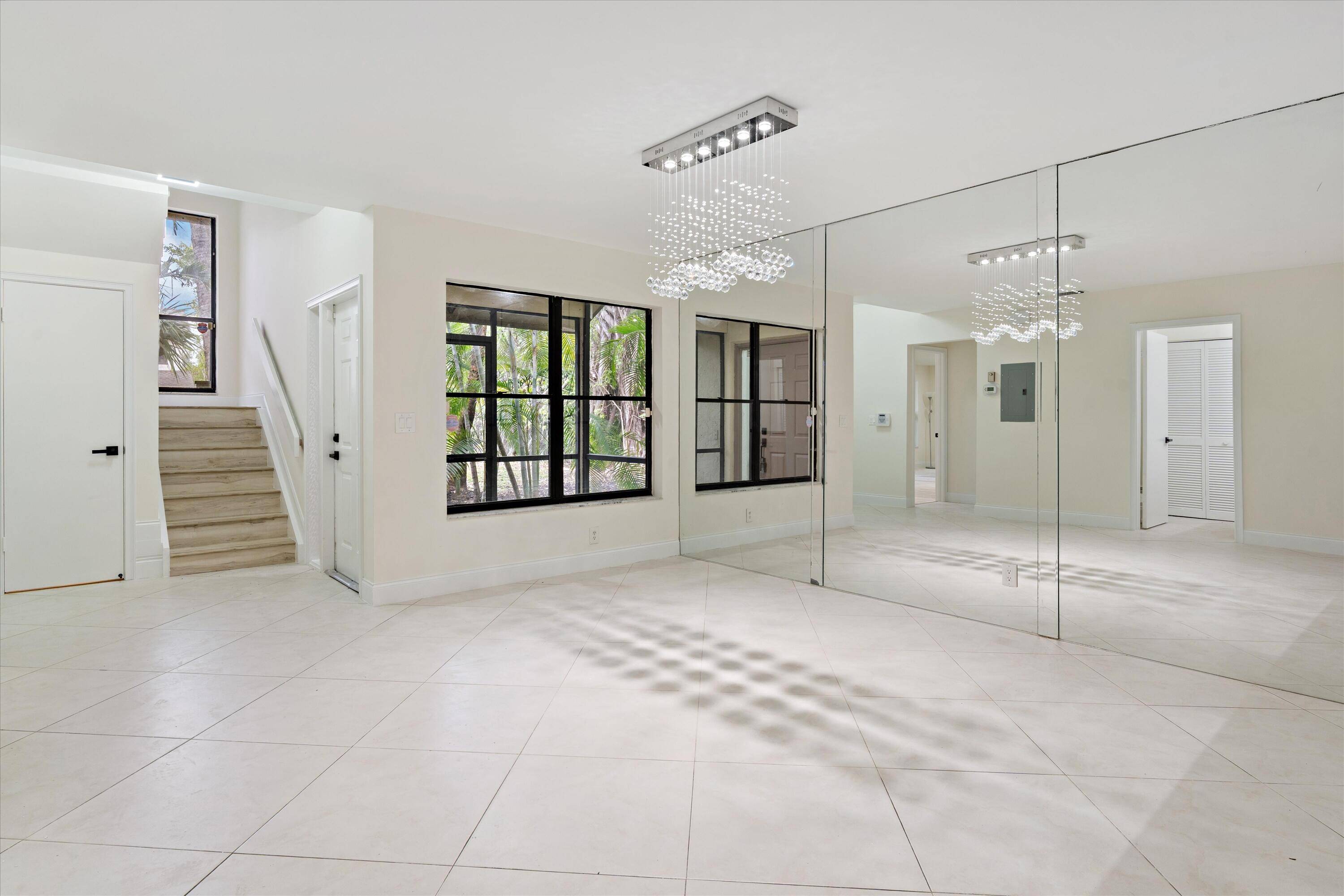 Discover this UNIQUE and BEAUTIFULLY RENOVATED lakefront corner town home, offering peace, privacy, lush tropical setting with a private side yard.