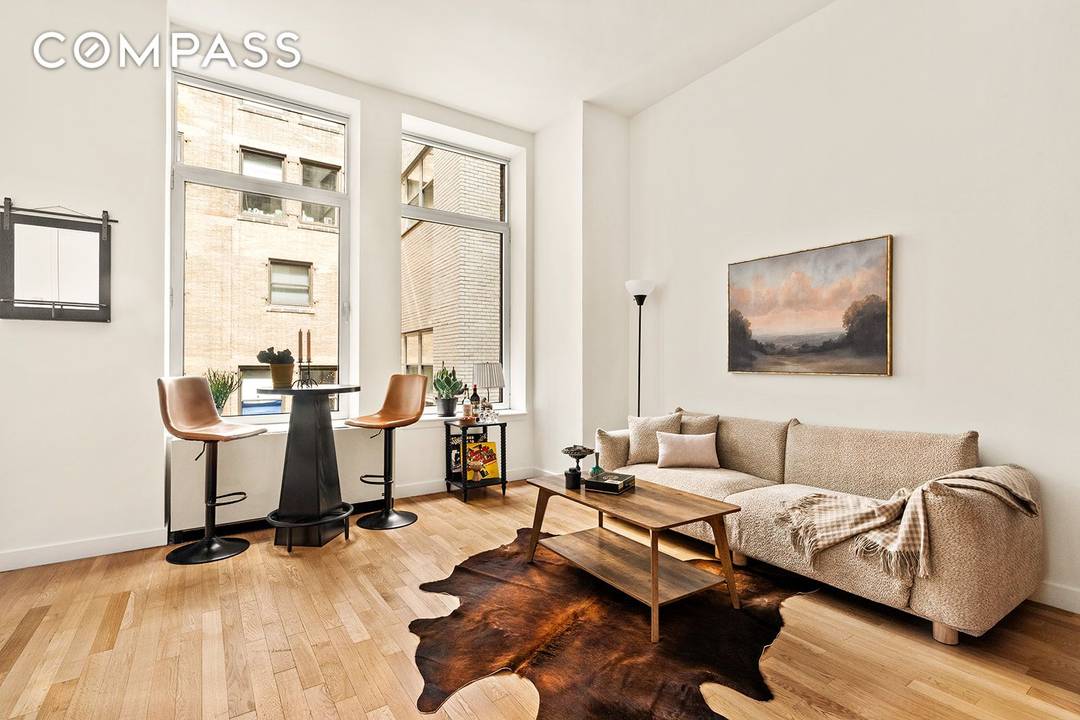 Spacious Alcove Studio with In Unit Washer Dryer in the Heart of FiDi Residence 7G is a thoughtfully designed alcove studio offering distinct spaces for living, dining, and sleeping.