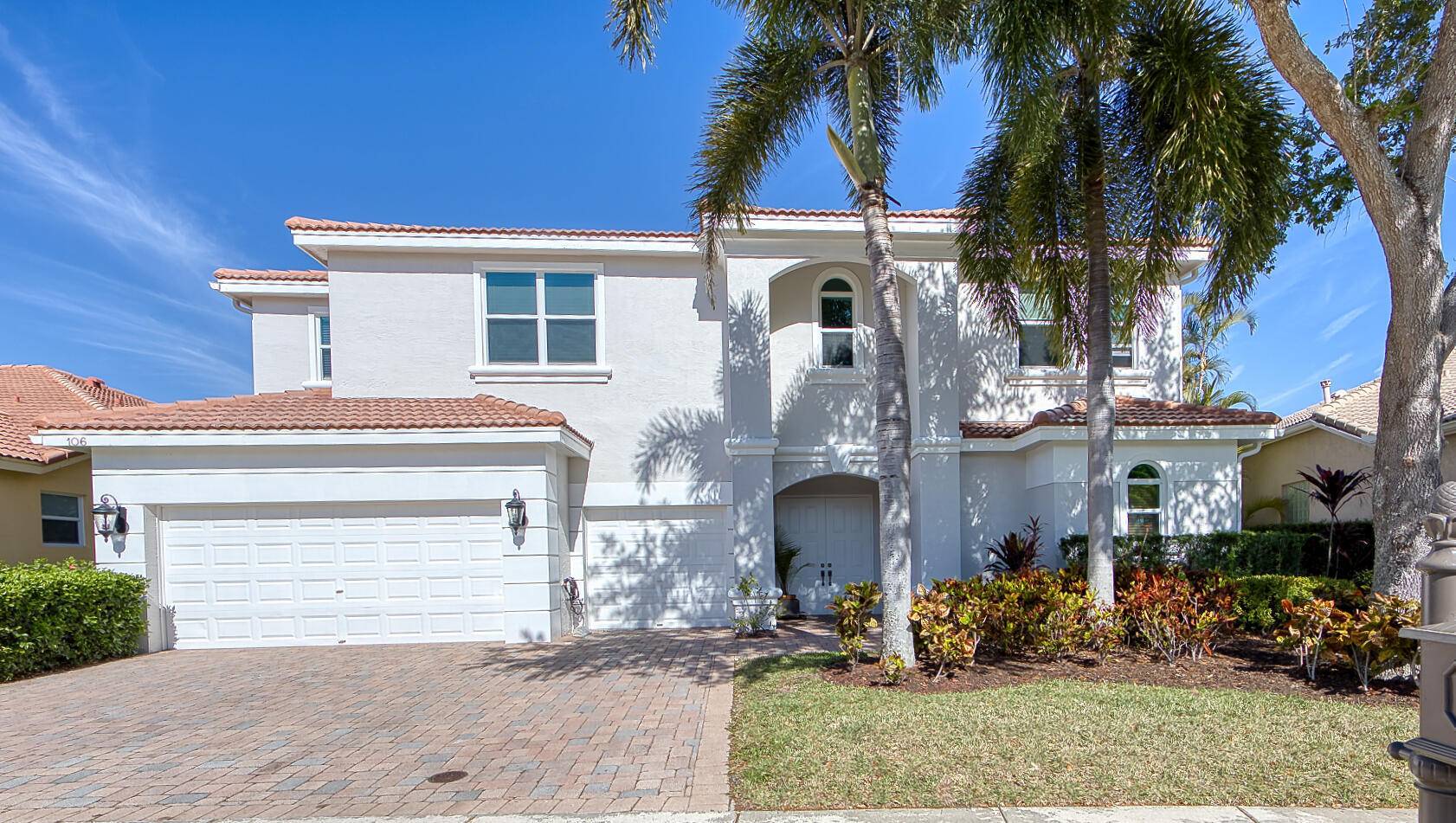 This courtyard home in a premier gated community offers spacious living areas with high ceilings and abundant natural light.