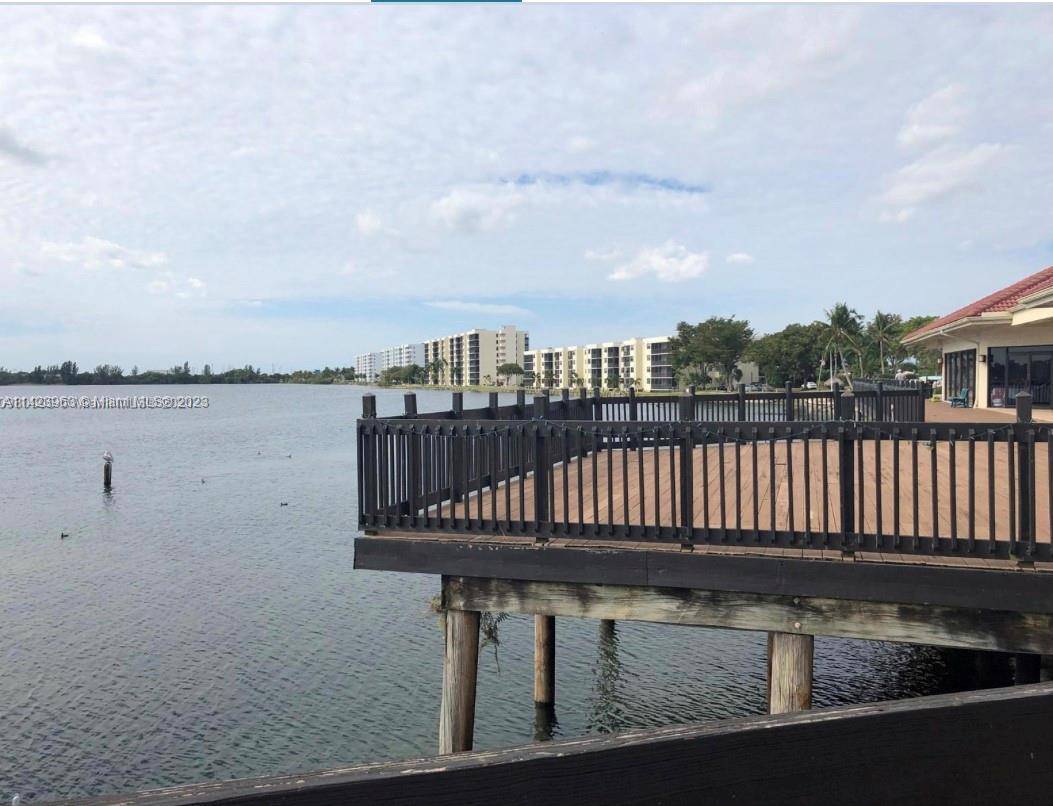 BEAUTIFUL modern and spacious 2 2 corner unit in gated community of Lake Emerald with panoramic waterfront views !