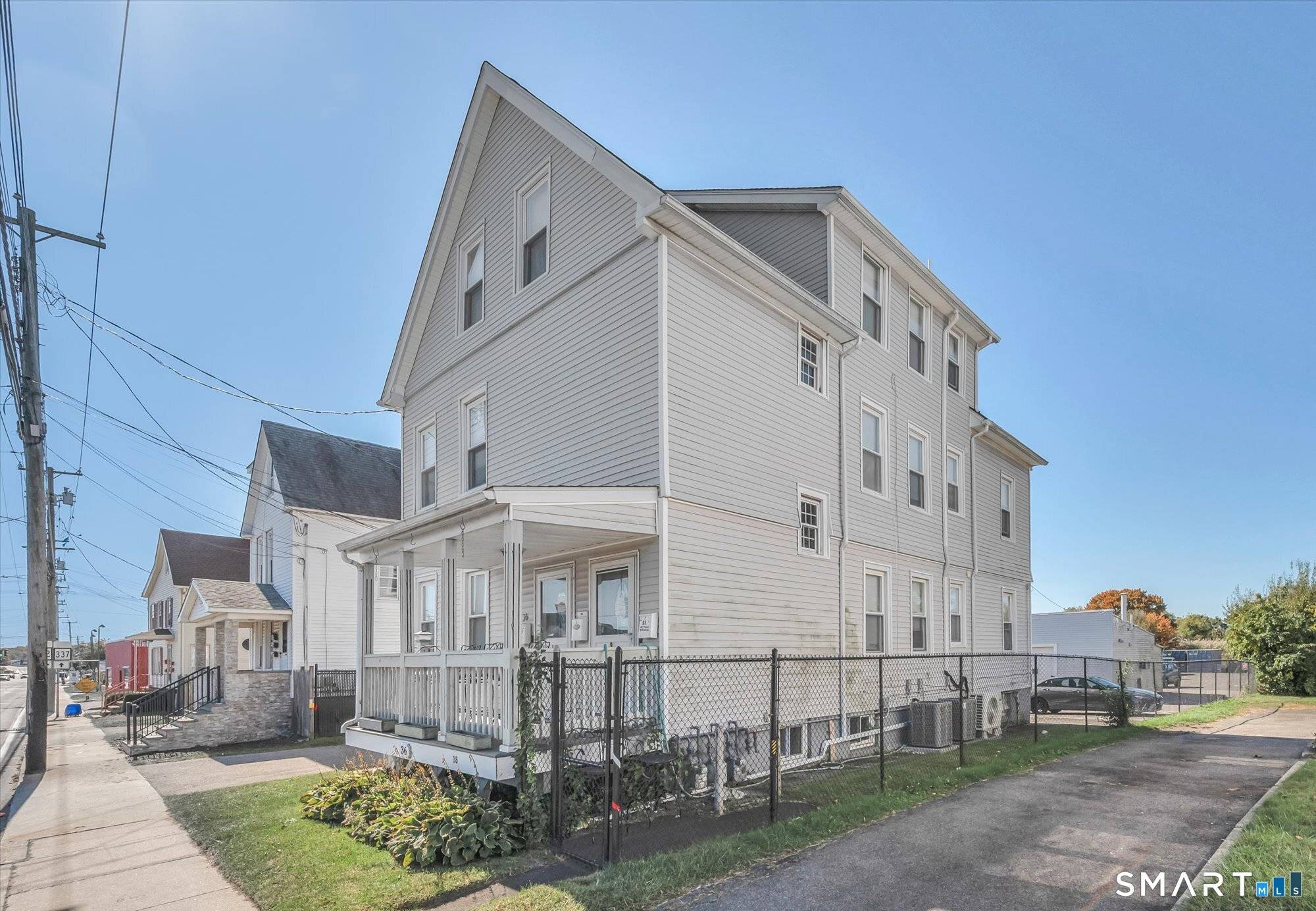 Incredible 3 family with commercial 2 car detached garage with back parking lot for at least 20 vehicles perfect area to lease spaces for cars RVs.
