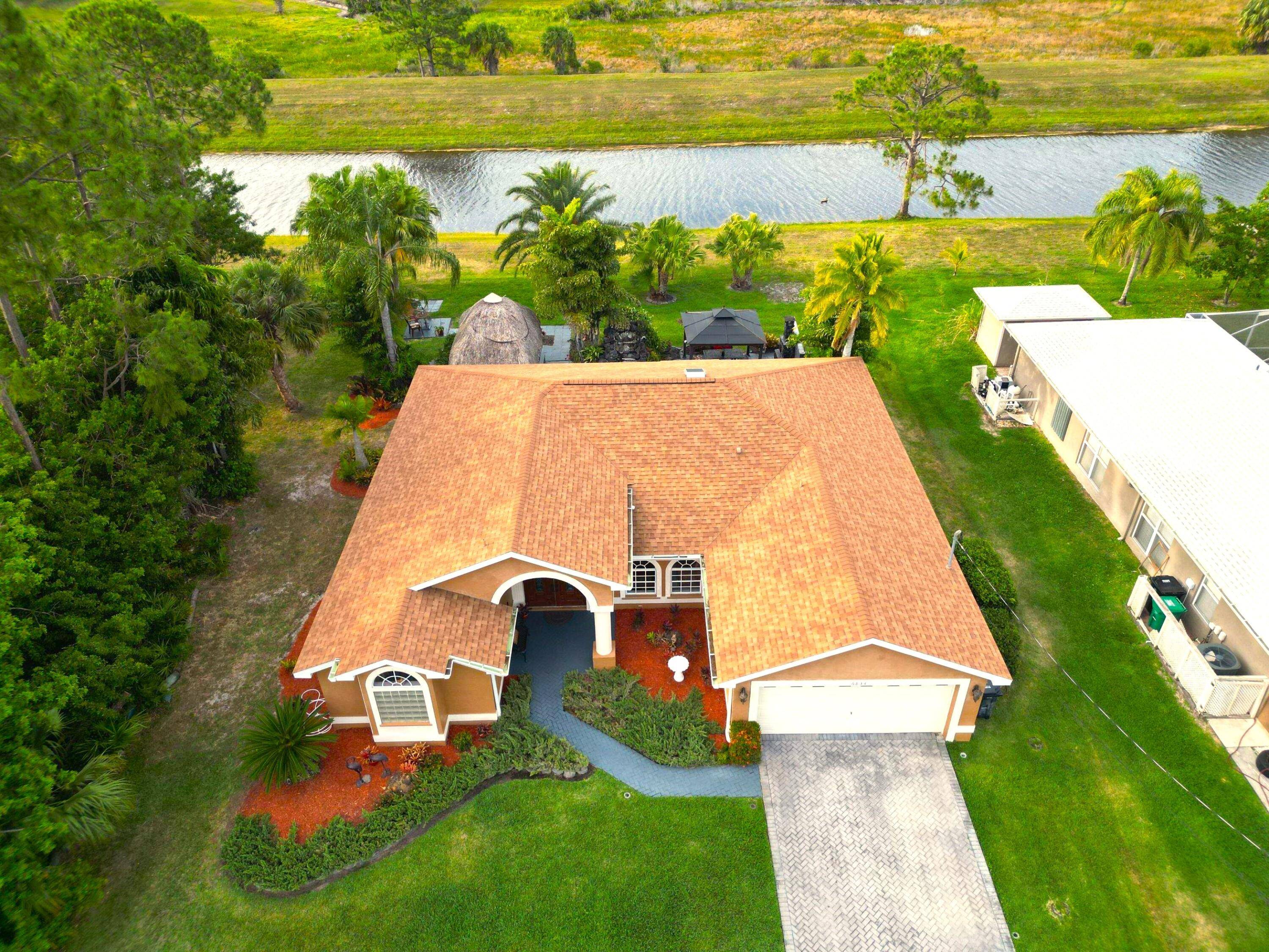 Welcome to Your Very Own Tropical Paradise OasisStep into luxury and tranquility in this impeccably crafted concrete home, showcasing a brand new roof and gutters installed in 2022, and a ...