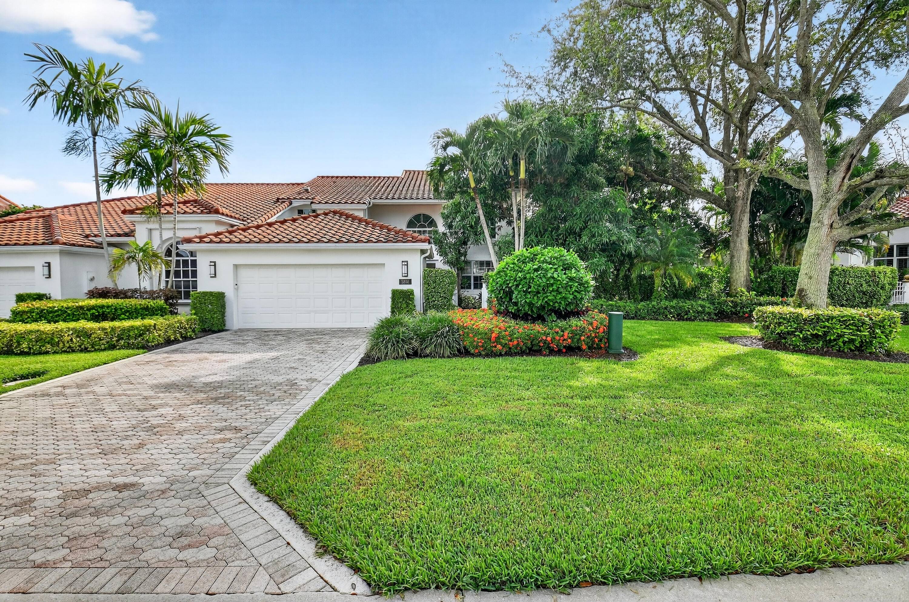 Nestled on one of the largest and most private lots in The Cloisters at Broken Sound Country Club, this residence blends timeless elegance with thoughtful modern updates.