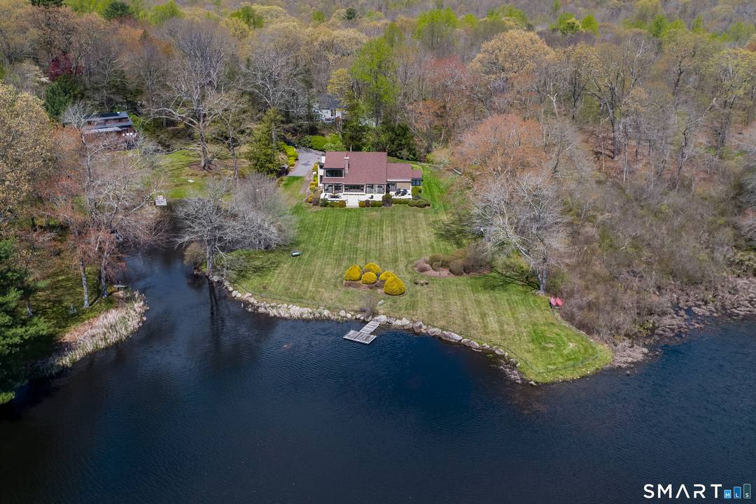 Embrace the waterfront lifestyle at 45 Falls River Drive, located on a designated scenic road in the charming village of Ivoryton within the Town of Essex.