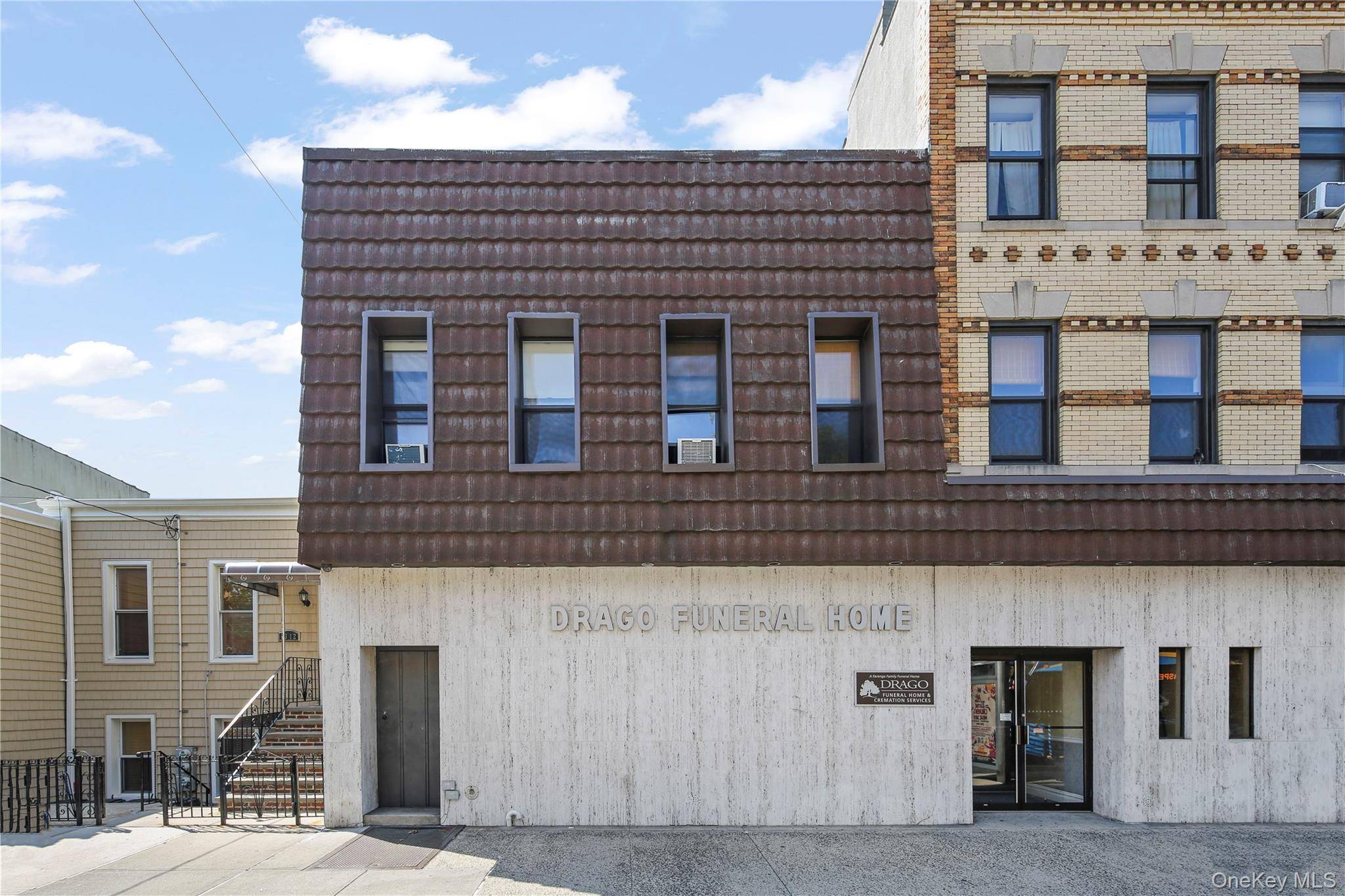 A substantial mixed use property featuring ground floor retail with residential units above.