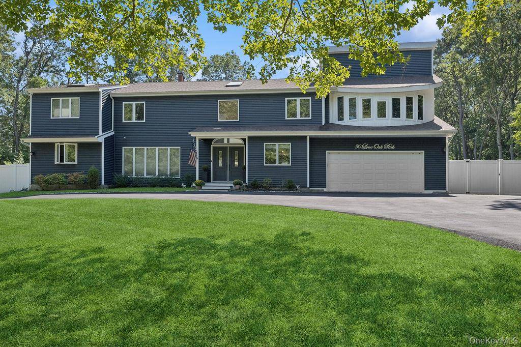 Welcome to 30 Lone Oak Path, a grand haven nestled in the heart of the highly sought hamlet of Smithtown Pines.