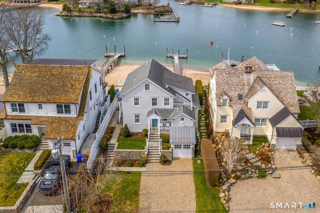 Set along the picturesque Five Mile River with its own private beach and dock, this exceptional waterfront home captures sweeping views of the Long Island Sound and unforgettable sunsets from ...