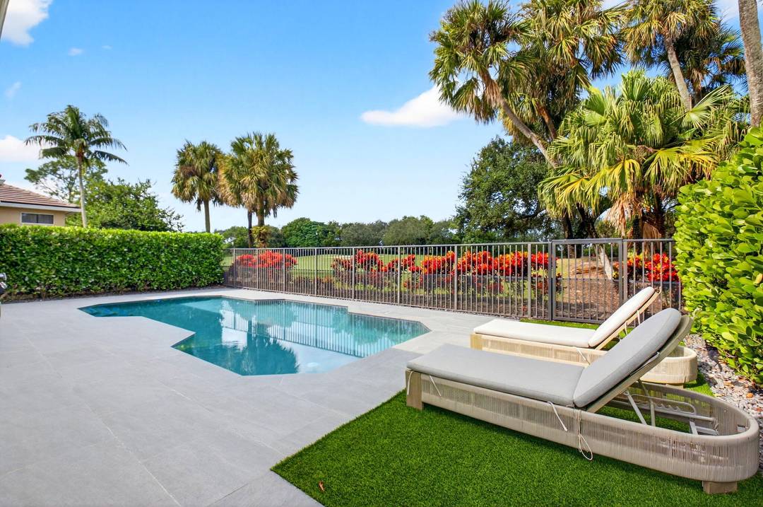 This immaculate 3 bedroom, 2 1 2 bathroom home located on Mizner Country Club's 10th green.