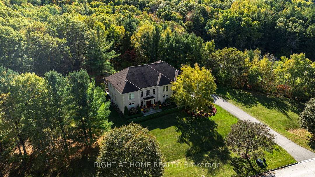 Experience upscale estate living at 65 Kingswood Drive, a stately multi generational residence set on 2.