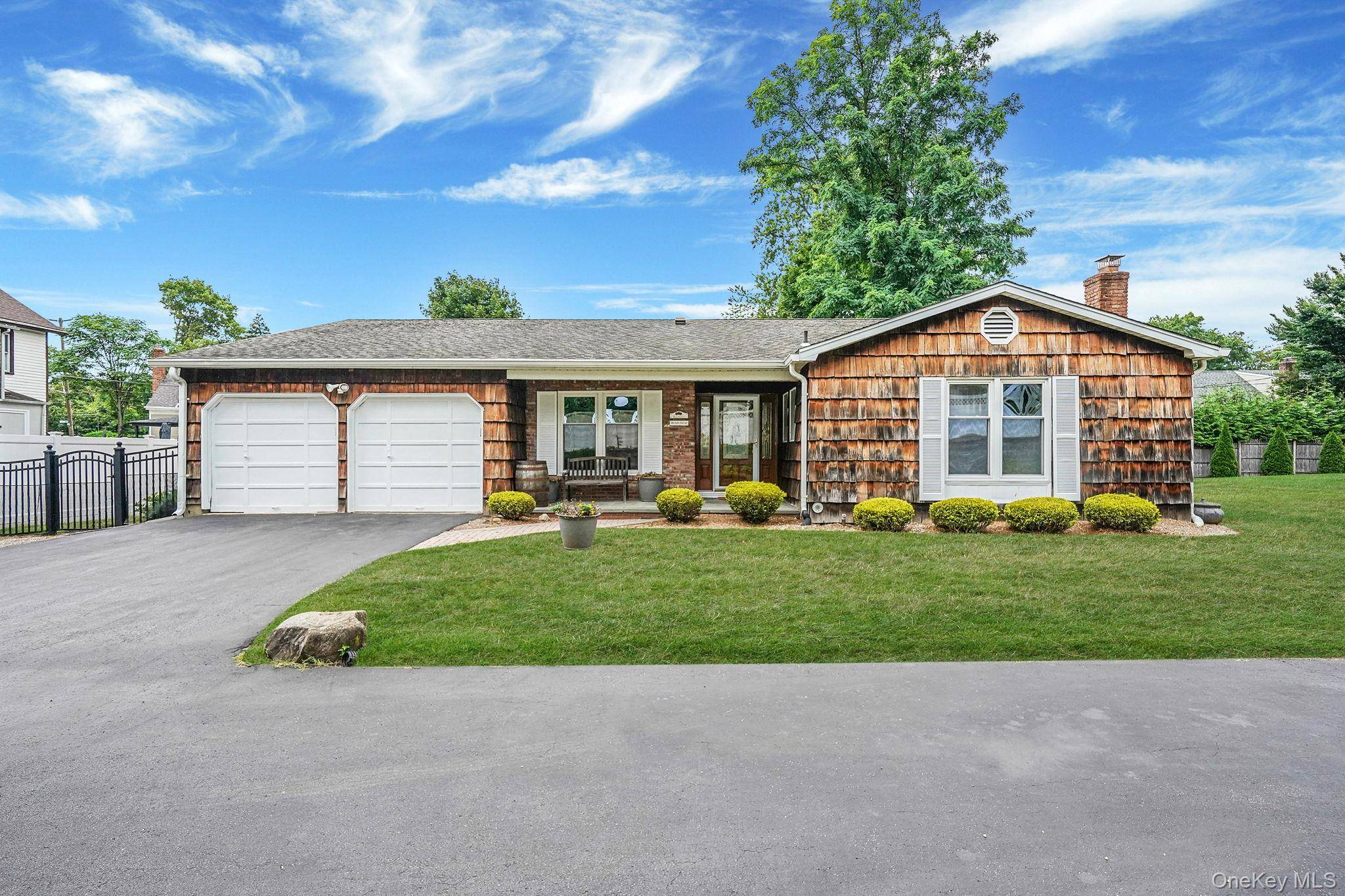 Set back on a quiet private road, this 3 bedroom, 2 bath ranch combines comfort and convenience in the heart of Glen Head.