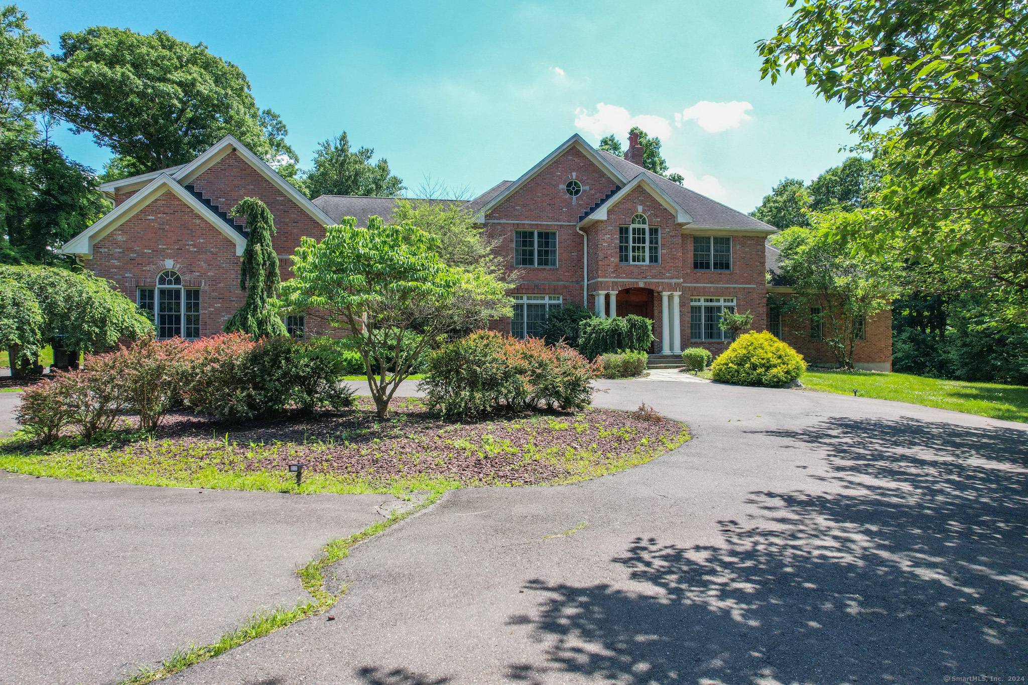 Welcome to 215 Old Mountain Rd, a luxurious brick colonial estate in Connecticut's desirable Farmington Valley.