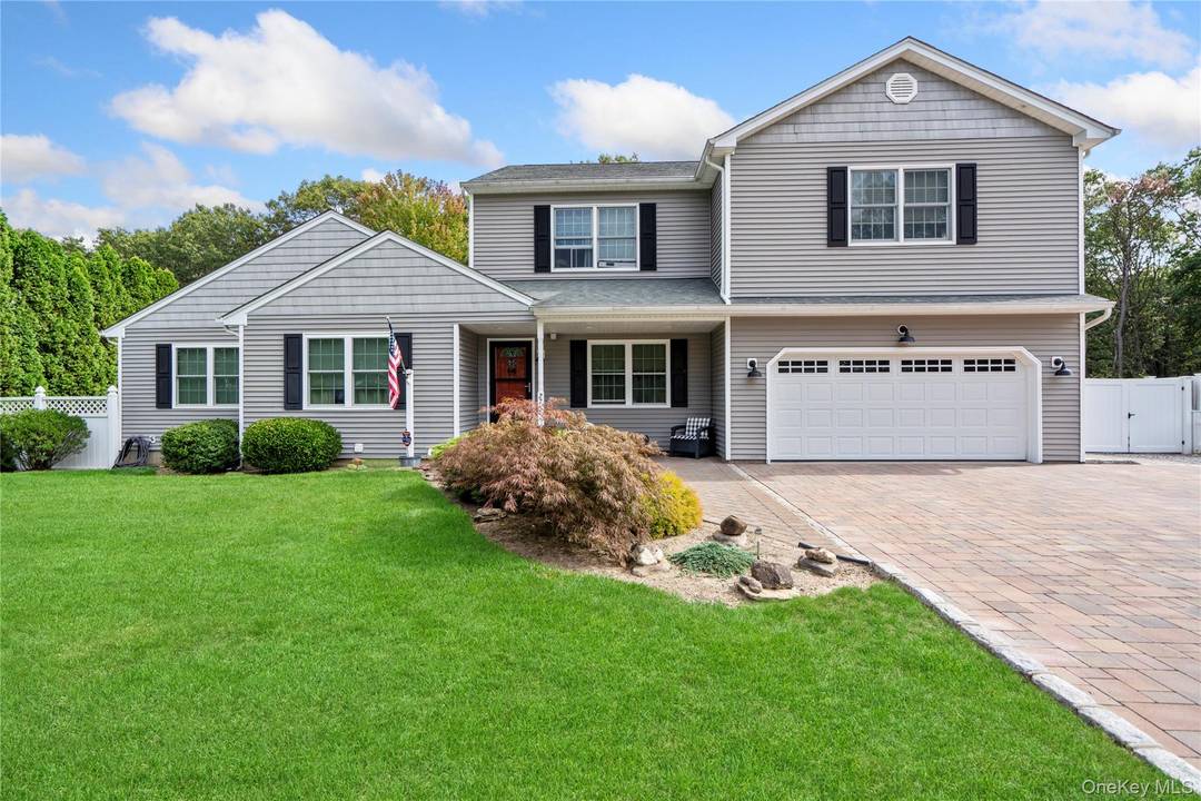 This sprawling Manorville colonial truly has it all.
