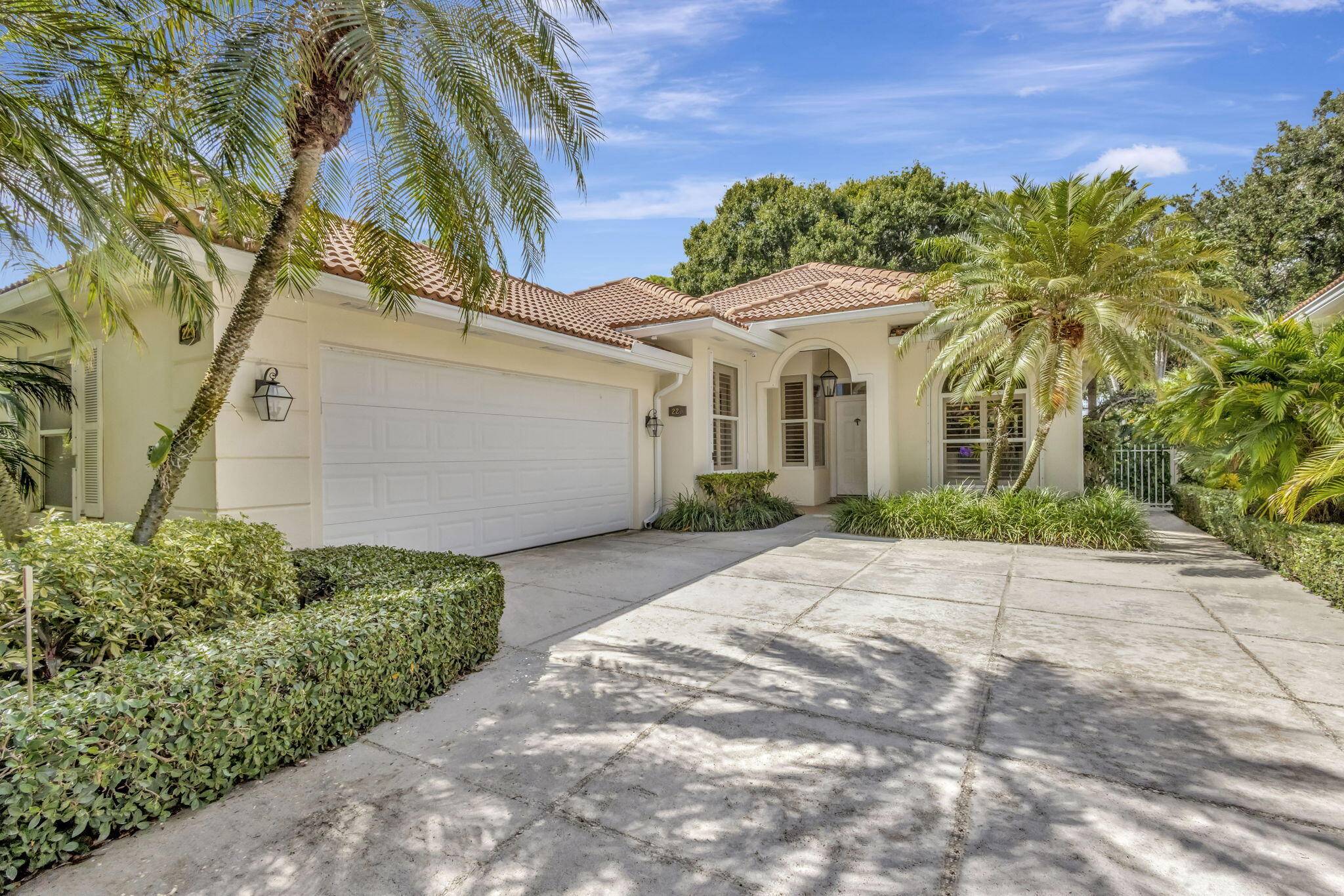 Welcome to your own private tropical sanctuary, tucked away in the highly sought after, guard gated community of Oaks East.