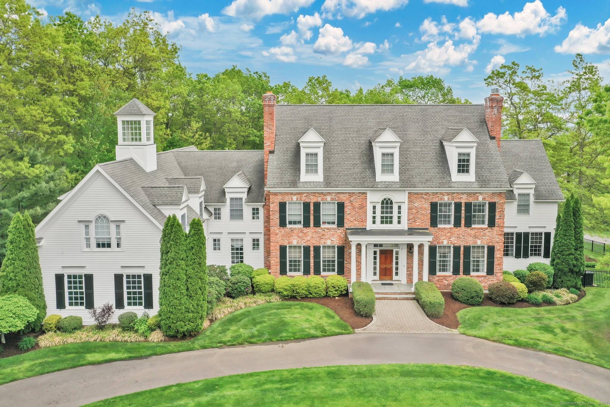 This magnificent brick and clapboard estate offers elegance sophistication with every detail meticulously crafted for refined living.
