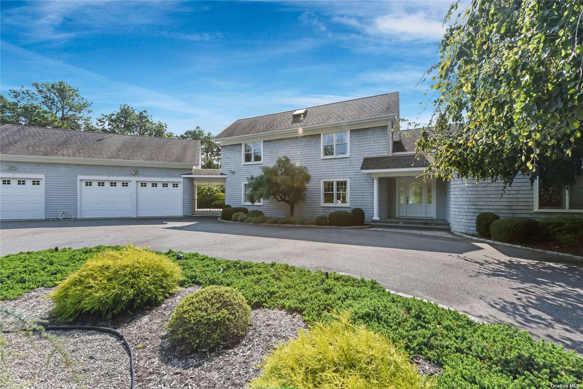 Enjoy this beautiful Contemporary Home in Quogue Village, sited on a lovely wooded 1.