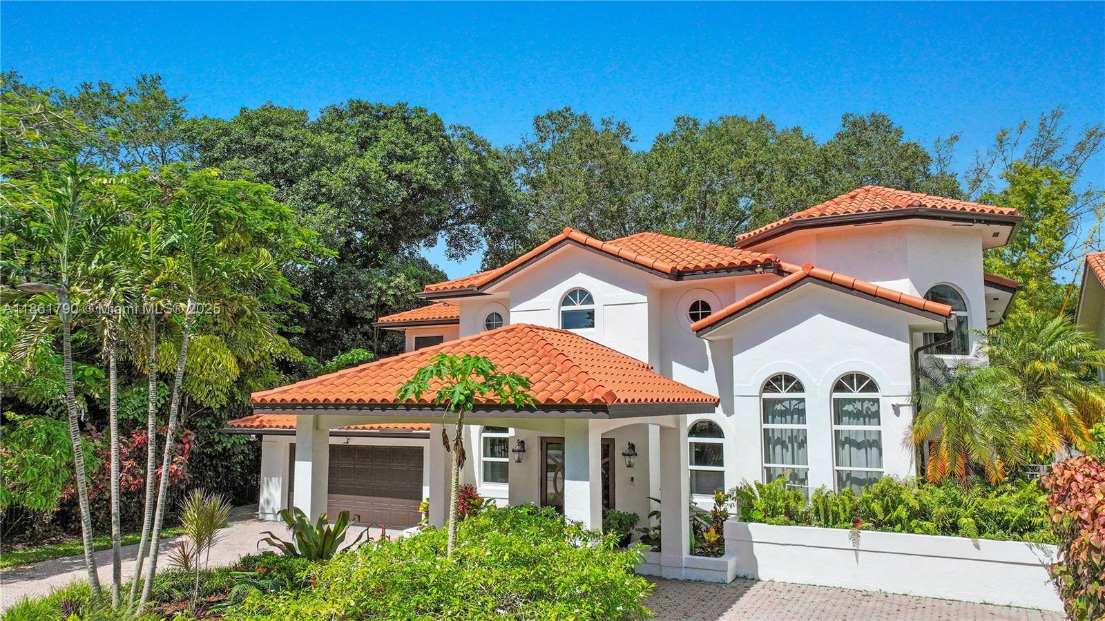 Stunning Mediterranean style villa nestled amidst lush gardens with detailed landscaping, located in the highly coveted and quaint neighborhood of South Miami.