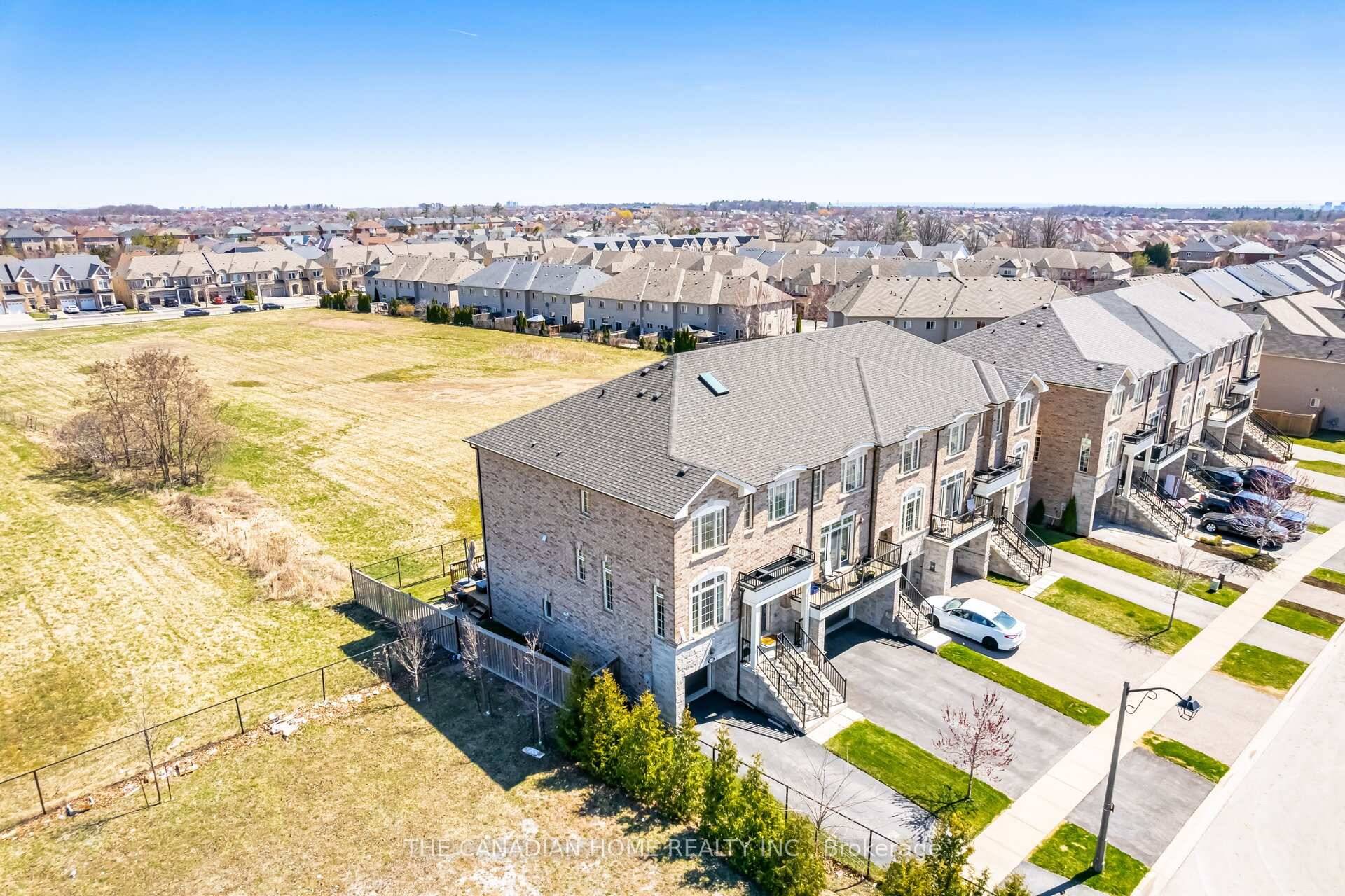 Rare end unit townhome with a walk out finished basement, on an oversized pie shaped lot in prestigious Westmount !