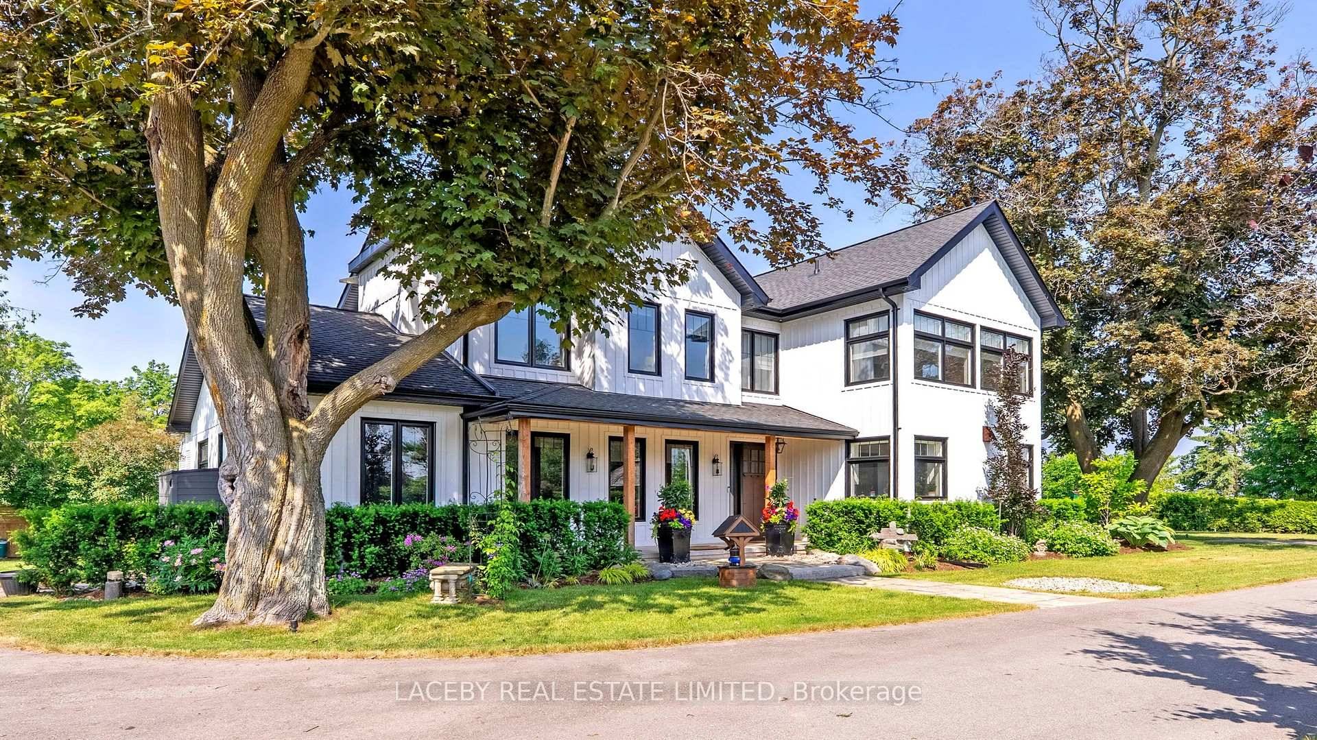 Discover unparalleled lakeside living in this custom built 2021 board and batten Cape Cod farmhouse, boasting approx.