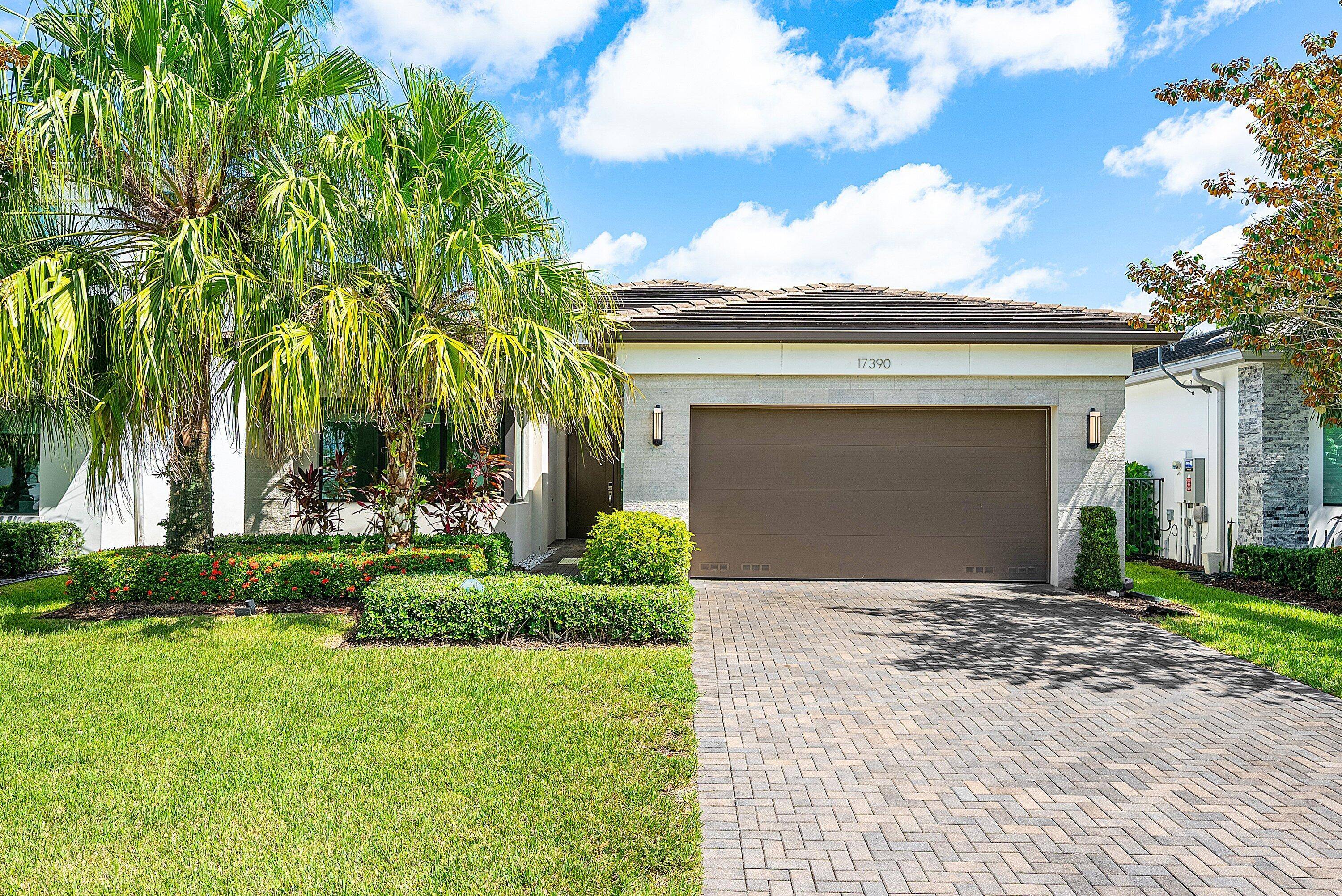 Step into modern luxury with this impeccable 3 bedroom plus den residence located in the highly sought after gated community of Lotus in Boca Raton.