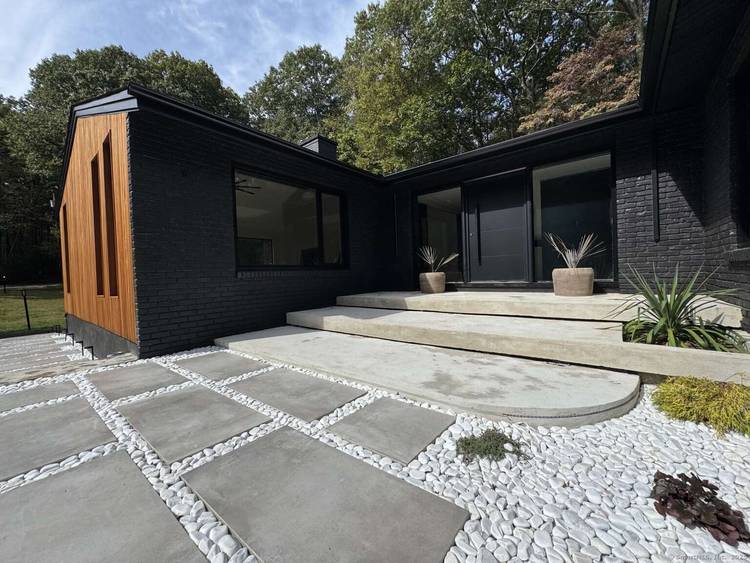 Set against the scenic Woodbridge Land Trust, this spacious 5 bedroom, 3.