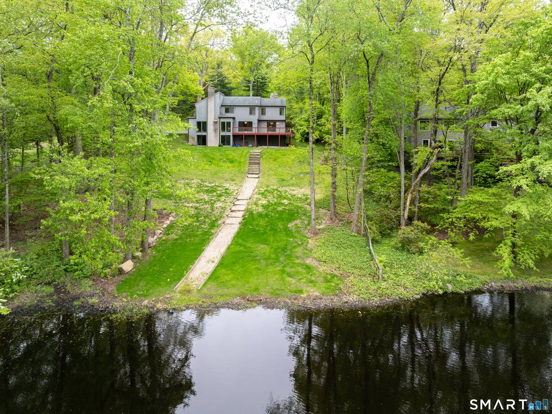 Perched on a scenic ridge overlooking the bucolic waters of Oriental Lodge Pond, this exceptional contemporary home is a sanctuary for those who crave a connection to the outdoors.