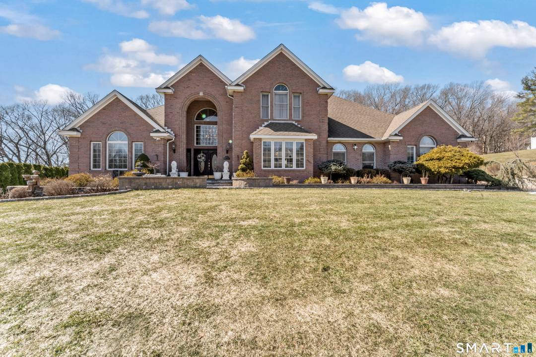 Stately custom brick Colonial set on a private lightly wooded 1.